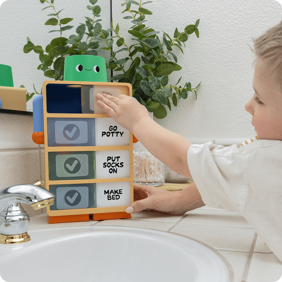 Toddler playing with the Routine Robot